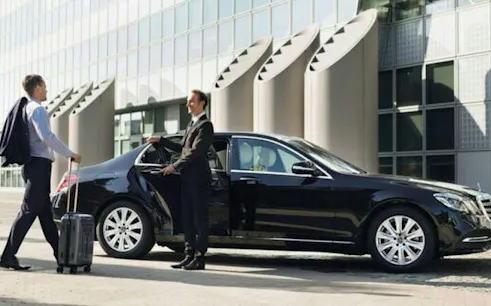 Businessman entering private car for transfer between Sharm El Sheikh and Nuweibaa City.