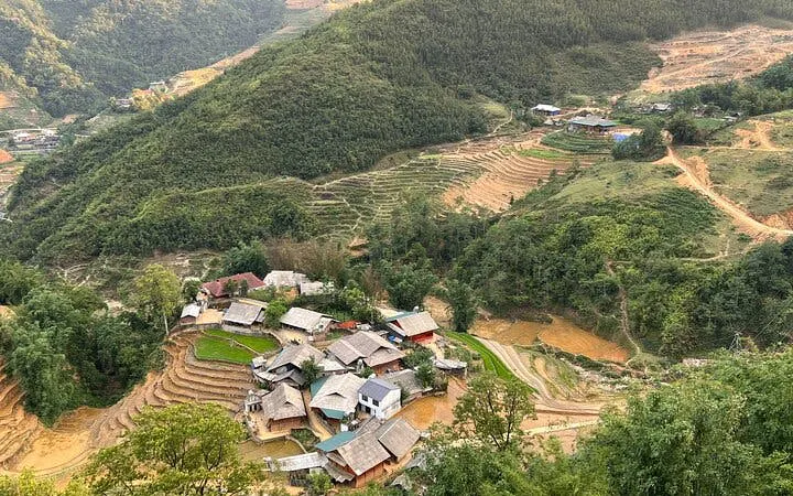 Sapa village with terraced rice fields and surrounding hills, part of motorbike tour including Cat Cat Village.