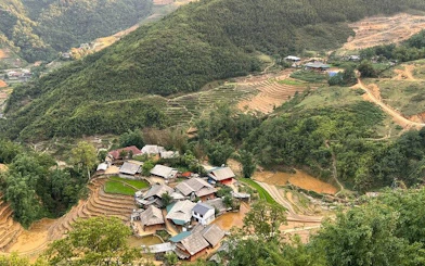 Sapa village with terraced rice fields and surrounding hills, part of motorbike tour including Cat Cat Village.