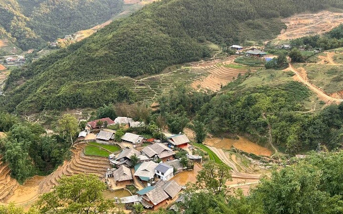 Sapa village with terraced rice fields and surrounding hills, part of motorbike tour including Cat Cat Village.