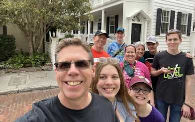 Group of tourists enjoying a self-guided exploration game in historic Charleston.