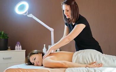 Massage therapist performing back massage in Marrakech spa.