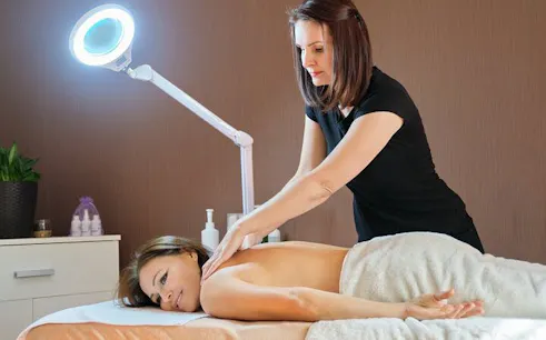 Massage therapist performing back massage in Marrakech spa.