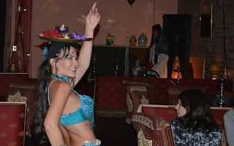 Cabaret performer balancing tray during dinner show in Hurghada.