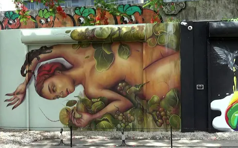 Berlin Wall mural depicting a reclining figure with leaves and grapes at East Side Gallery.