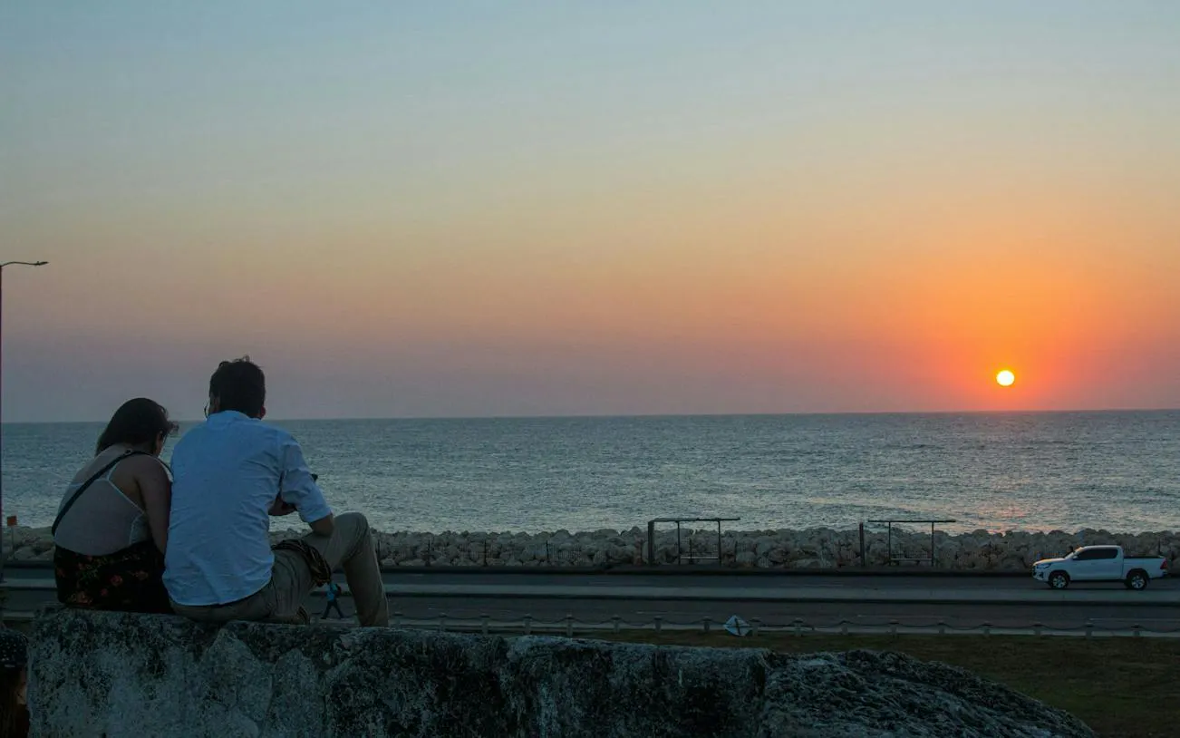 Couple watching sunset over the sea from Cartagena Walled City.
