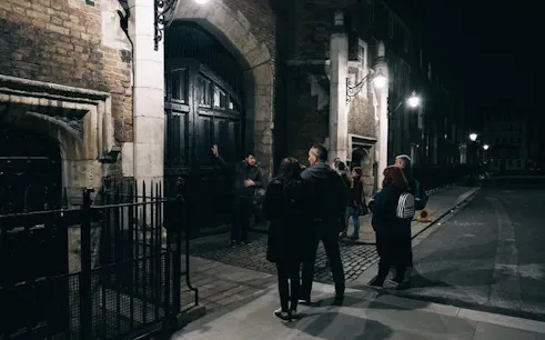 Group on Little Venice ghost walk by canal at night.