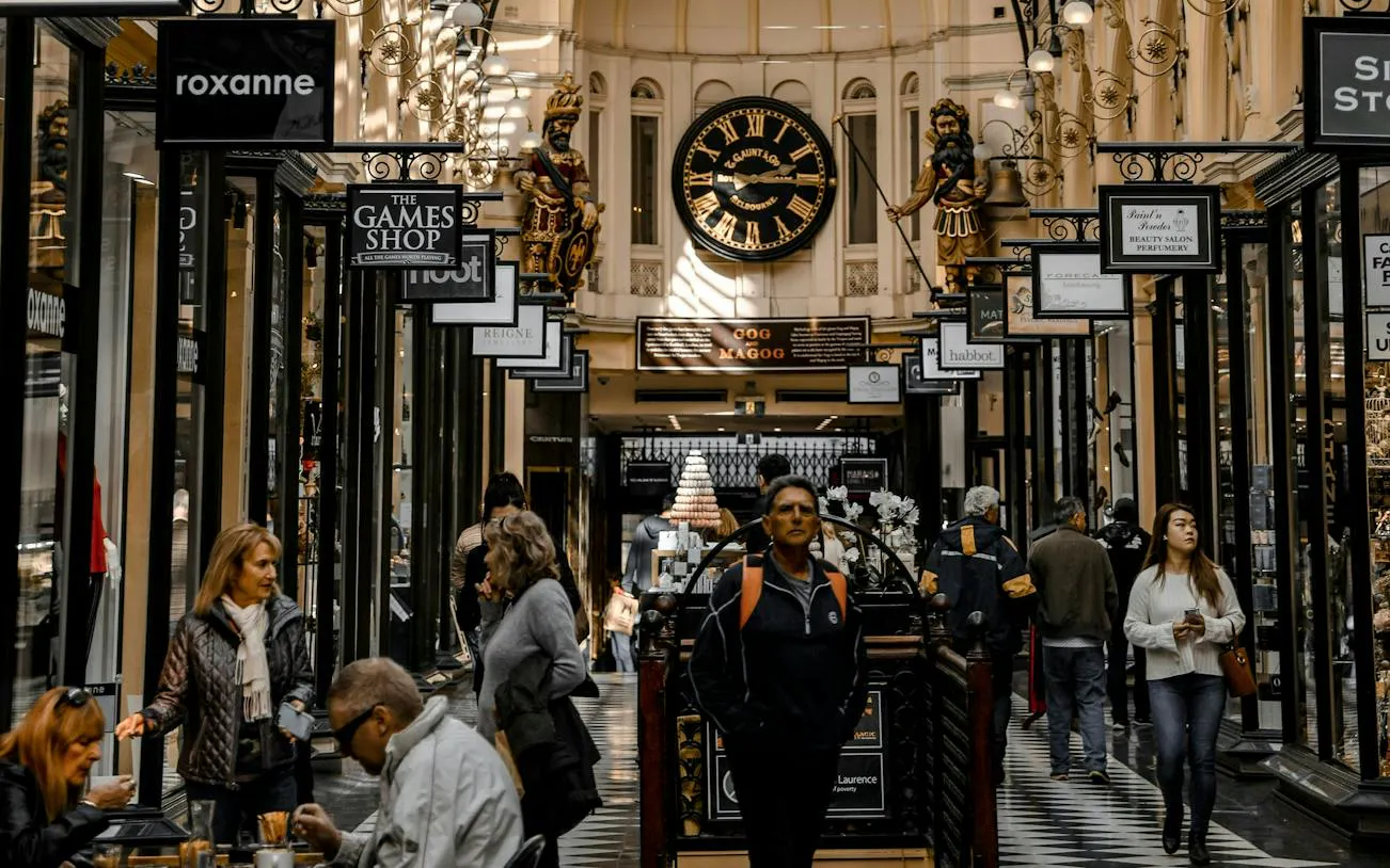 Melbourne's Royal Arcade with shoppers and historic clock on self-guided audio tour.
