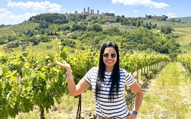Vineyard in Tuscany with view of San Gimignano towers in the background.