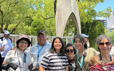 Group of tourists at Hiroshima Peace Memorial Park near the Children's Peace Monument.