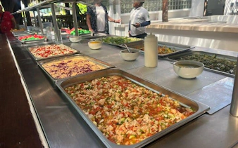 Buffet with fresh salads and dishes at Isla Mujeres beach club during catamaran tour.