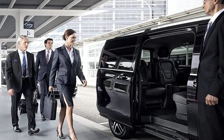Business travelers boarding a private van for transfer between Agadir and Marrakesh.