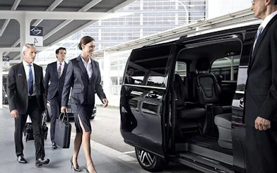 Business travelers boarding a private van for transfer between Agadir and Marrakesh.