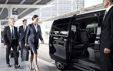 Business travelers boarding a private van for transfer between Agadir and Marrakesh.