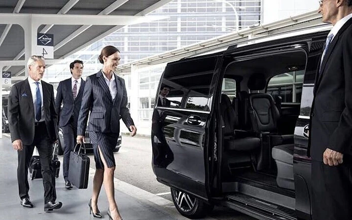Business travelers boarding a private van for transfer between Agadir and Marrakesh.