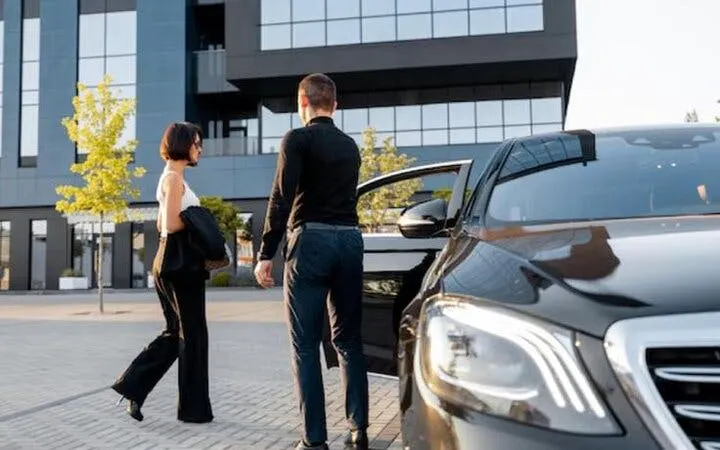 Transfer service at Sharm El Sheikh airport with luxury car and passengers.