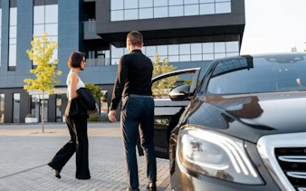 Transfer service at Sharm El Sheikh airport with luxury car and passengers.