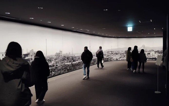Visitors viewing Hiroshima Peace Memorial Museum exhibit.