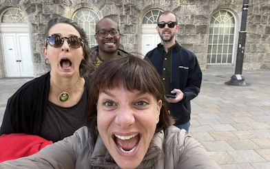 Group of people excitedly exploring Birmingham on a haunted city game tour.