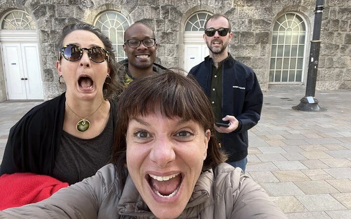 Group of people excitedly exploring Birmingham on a haunted city game tour.
