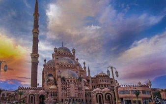 Mosque with intricate domes and minaret at sunset, Sharm El Sheikh city tour.