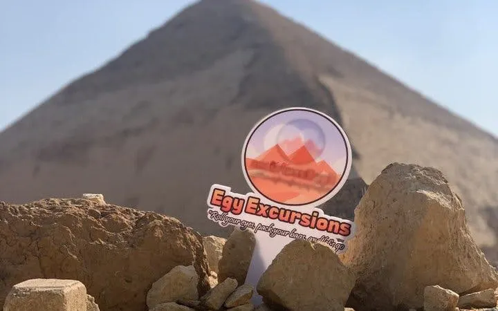Saqqara pyramid with tour sign in foreground, part of Memphis and Dahshur guided day tour.