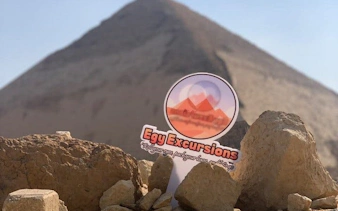 Saqqara pyramid with tour sign in foreground, part of Memphis and Dahshur guided day tour.