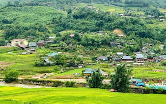 Sapa valley landscape with terraced rice fields and stilt houses, Vietnam.