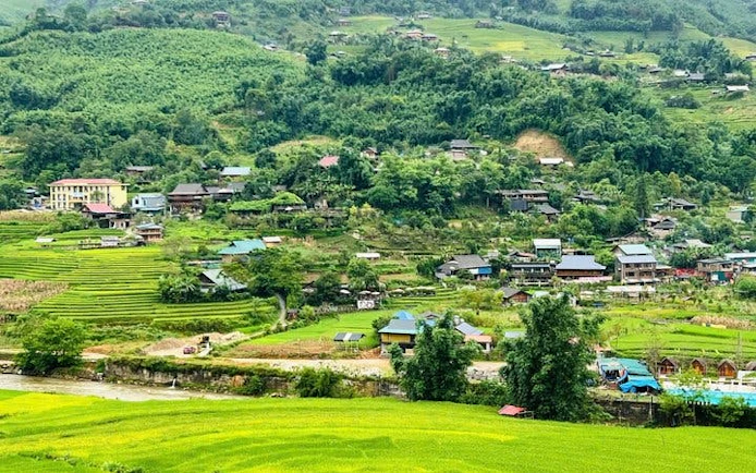 Sapa valley landscape with terraced rice fields and stilt houses, Vietnam.