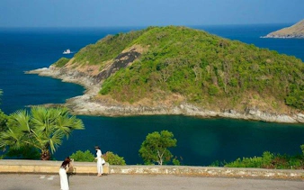 Phuket coastal view with lush island and tourists, part of Phuket City Highlights tour.