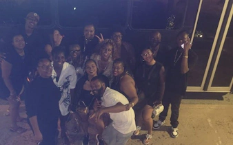 Group enjoying Sint Maarten Party Bus Nightlife Tour with bar stops and shots.