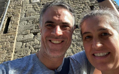 Couple exploring historic stone building in Florence during haunted city game.