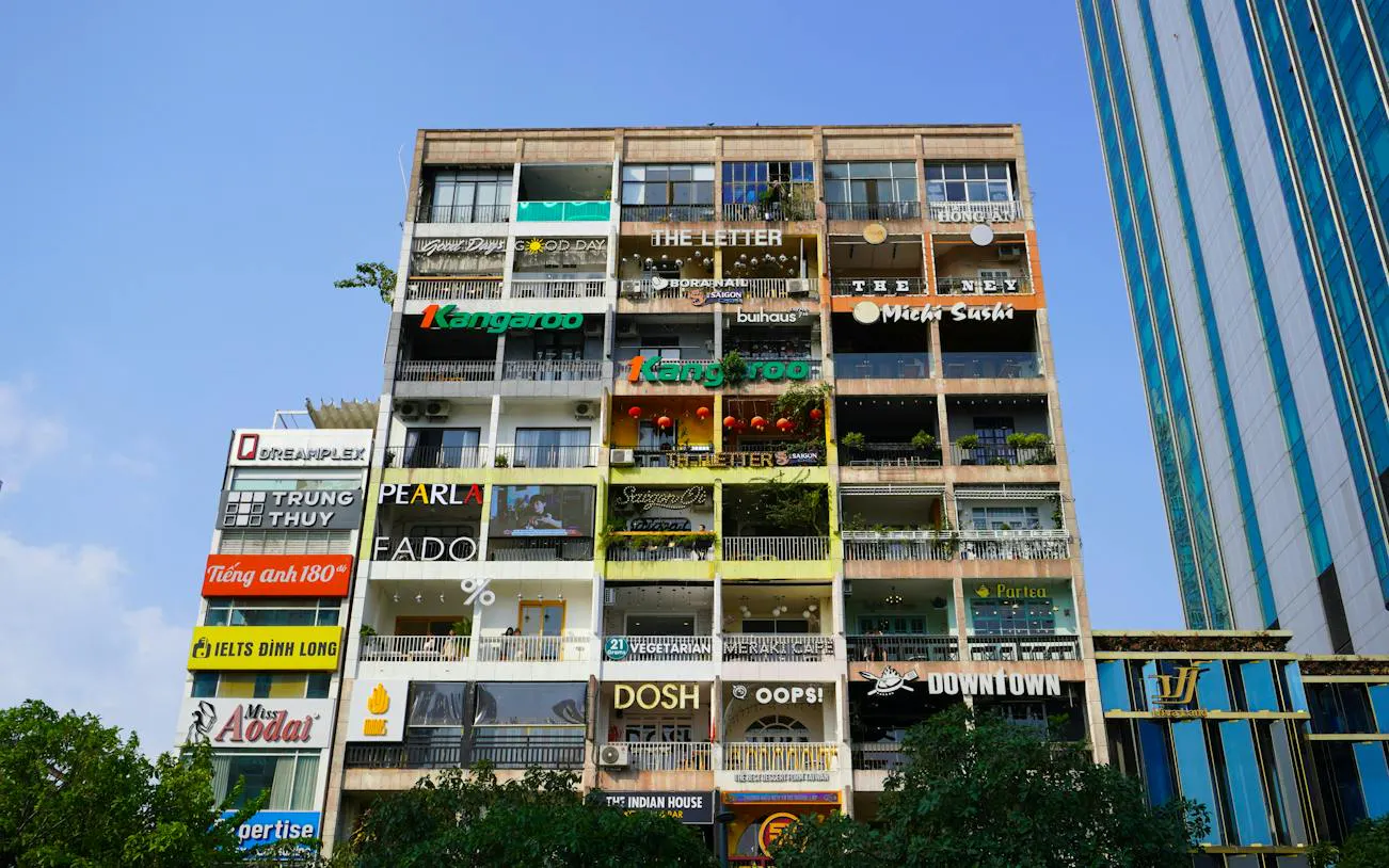Multi-story building with cafes and shops in Ho Chi Minh City's French Quarter.