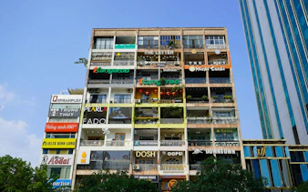 Multi-story building with cafes and shops in Ho Chi Minh City's French Quarter.