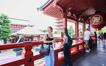 Visitors enjoying the view from Senso-ji Temple in Asakusa, Tokyo during a walking tour.