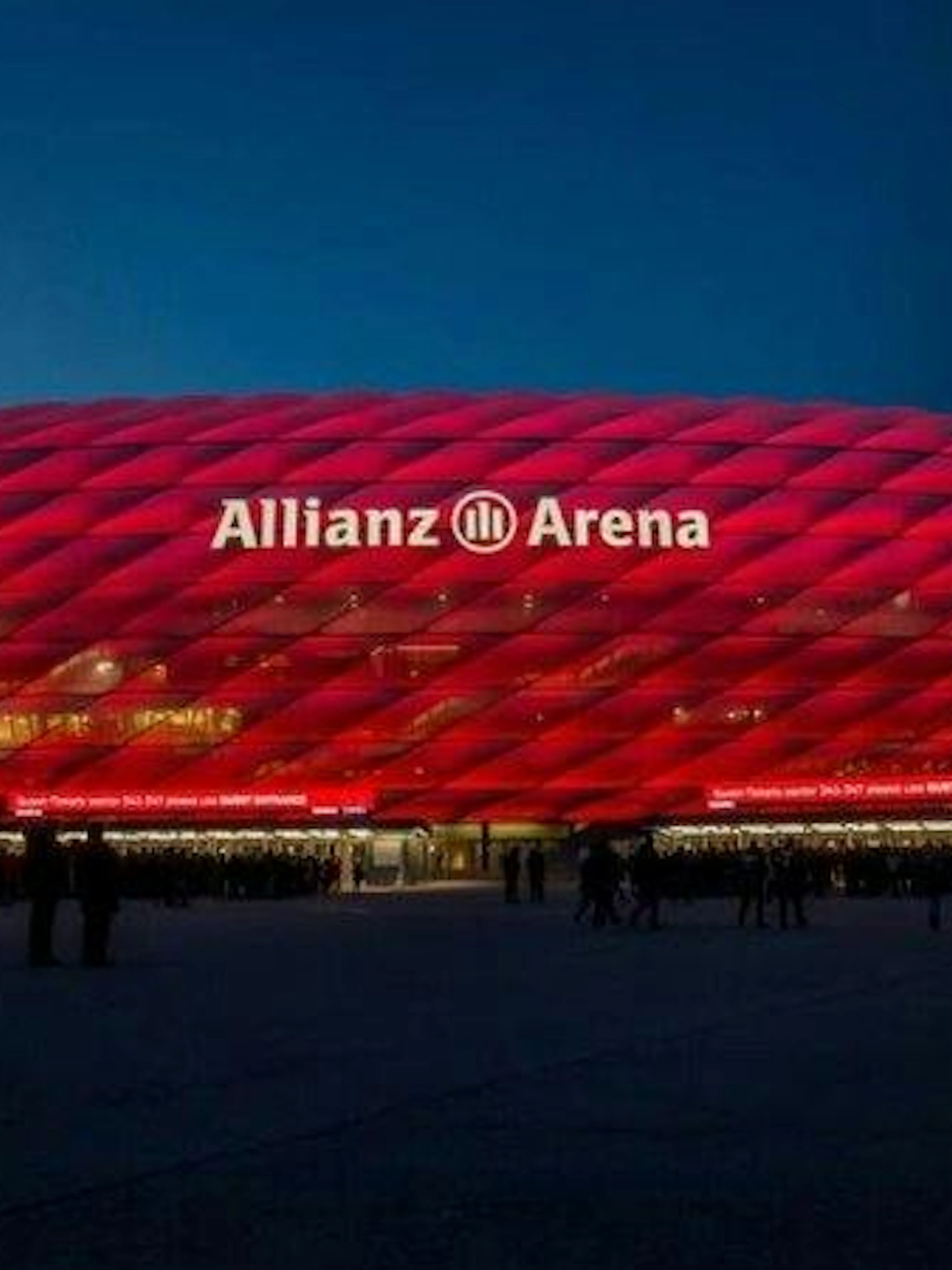 Allianz Arena illuminated at night, Munich, part of Vienna to Munich transfer tour.