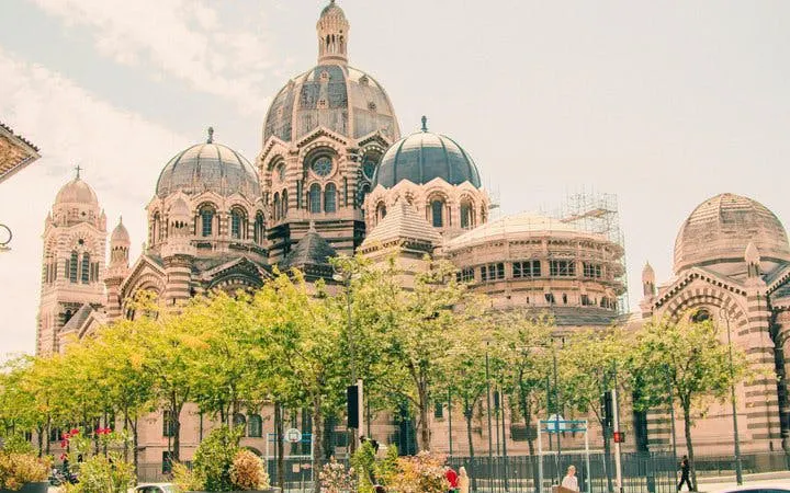 Marseille Cathedral with trees in foreground on self-guided walking tour.