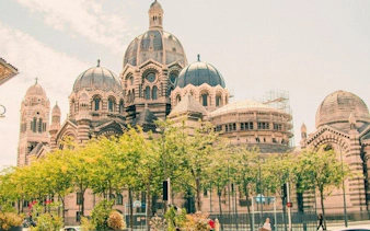 Marseille Cathedral with trees in foreground on self-guided walking tour.