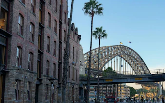 Historic buildings and Sydney Harbour Bridge on a self-guided audio walking tour from The Rocks to the Opera House.