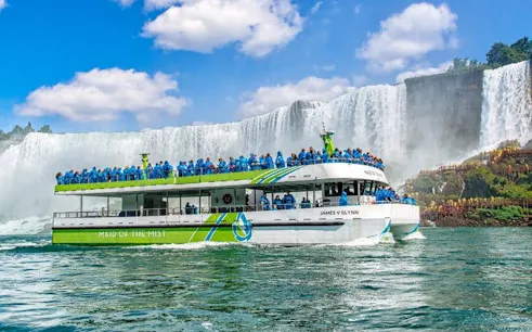 Maid of the Mist boat near Niagara Falls with tourists on a guided tour.