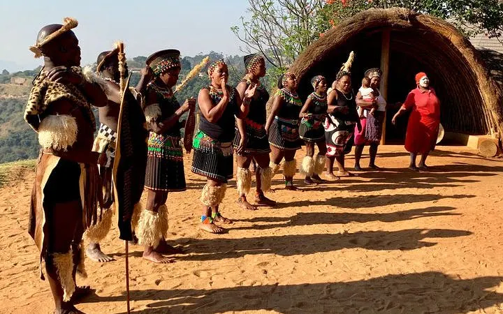 Zulu dancers performing in traditional attire at a cultural village near Durban.