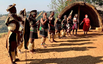 Zulu dancers performing in traditional attire at a cultural village near Durban.