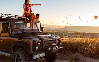 Cappadocia Jeep Safari with hot air balloons at sunrise.