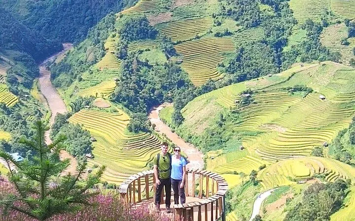 Tourists on a platform overlooking terraced rice fields in Mu Cang Chai, Northern Vietnam.