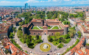 Aerial view of Sforza Castle in Milan, Italy, surrounded by cityscape and greenery.