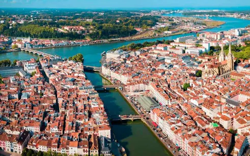 Aerial view of Bayonne, France, featuring the Nive River and historic architecture.