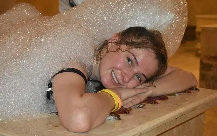 Person enjoying a traditional Moroccan hammam with soap suds in Marrakech.