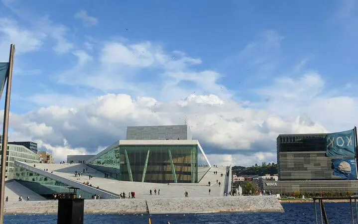Oslo Opera House with visitors walking on the sloped roof, Oslo Walking Tour.