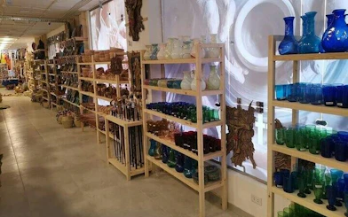 Shelves of colorful glassware and crafts in a Hurghada market shop.