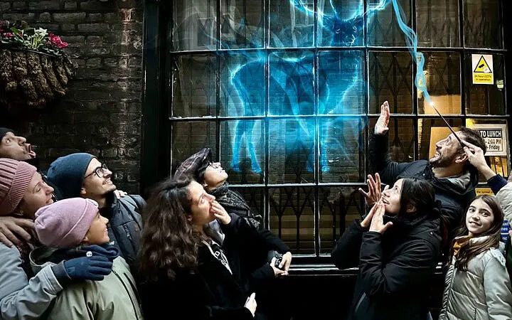 Group on Harry Potter tour in York watching a magical projection on a window.